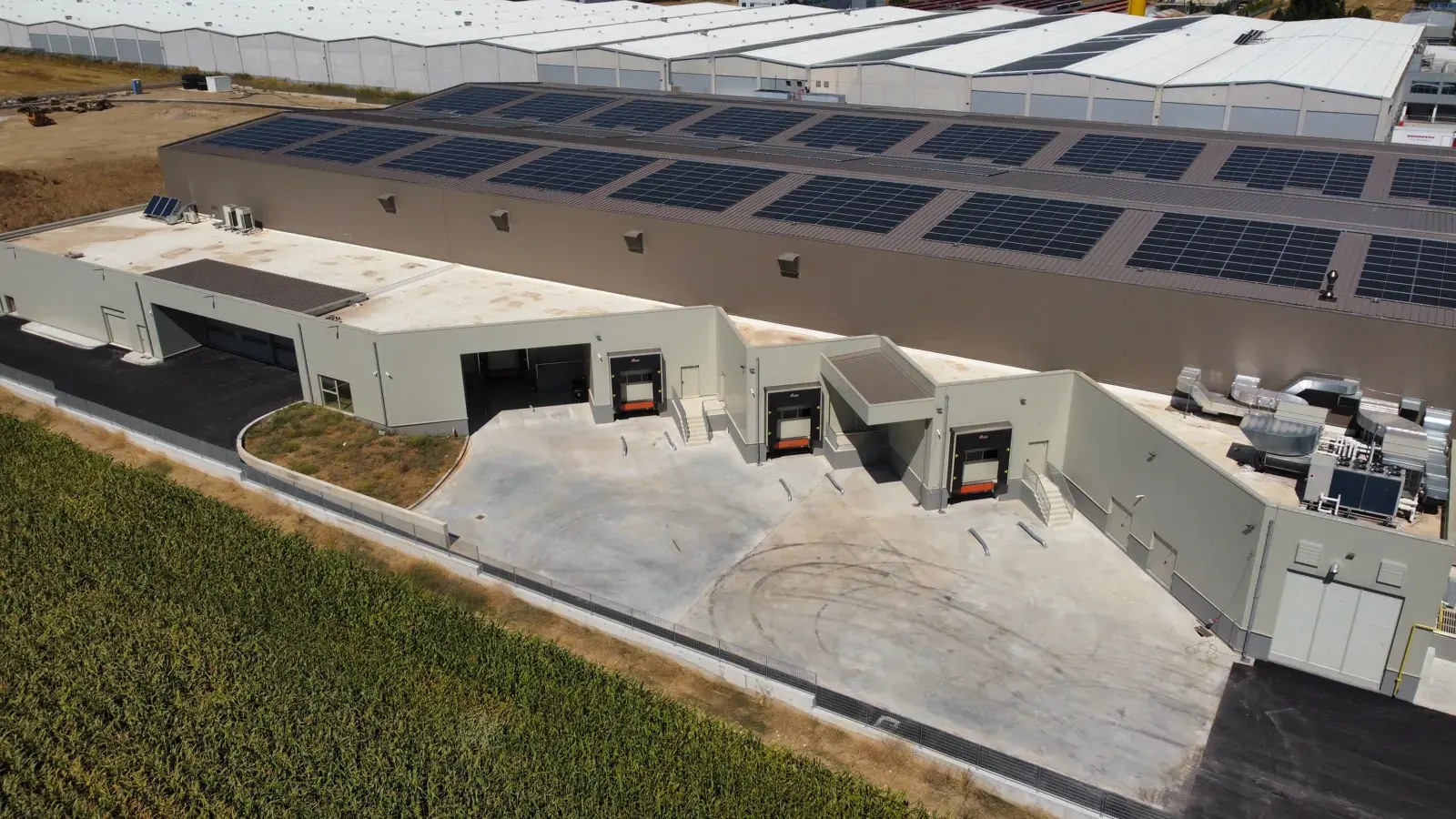 Coffee production facility — exterior with solar panels and loading docks
